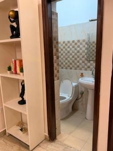 a bathroom with a toilet and a sink at Your Cozy Escape in Jammu +12 photos