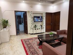 a living room with a couch and a table at Your Cozy Escape in Jammu