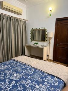 a bedroom with a bed and a mirror at Your Cozy Escape in Jammu