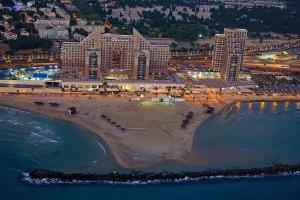 an aerial view of a beach at night at מגדל הים - בניין אלמוג in Haifa