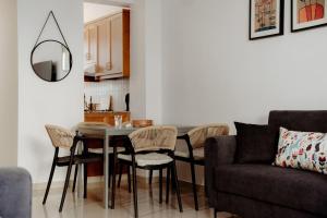 a living room with a table and chairs and a couch at Toma Villa in Paralimni