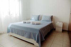 a bedroom with a bed with two towels on it at Toma Villa in Paralimni +24 photos