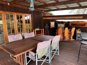 a wooden table and chairs on a deck at Boskoors in Hammanskraal