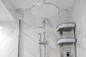 a shower with three shower heads in a bathroom at Ocean View Ponderosa 601 Costa Adeje Playa de las Americas in Costa de Adeje