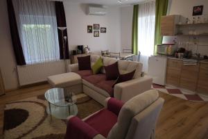 a living room with a couch and a table at Szántó Villa in Hévíz