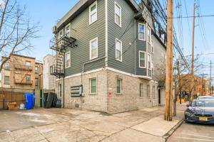 a large green house with a car parked in front of it at Spacious 3BR 2BA Apt with Private Parking Walk to PATH in Jersey City +30 photos