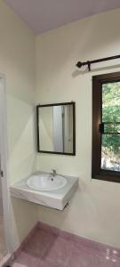 a white bathroom with a sink and a mirror at Happy Bungalow in Ko Tao