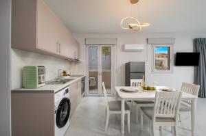 a kitchen and dining room with a table and a stove at Kamara View Apt 1 in Agios Nikolaos