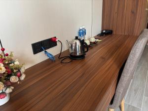 a long wooden table with a tea kettle on it at D02 - Happy Beach Villas - No2 Căn hộ Z&Z Triple key - NovaWorld Ho tram in Binh Chau