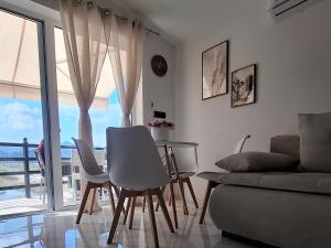 a living room with a table and chairs and a couch at Lake View Terrace Apartment Dapcevic in Vranjina