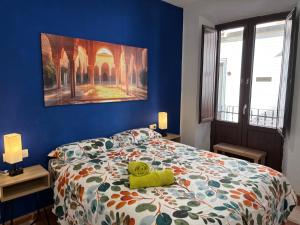 a bedroom with a teddy bear laying on a bed at Oh! My Hostel in Granada