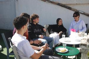 a group of people sitting around a table at Oh! My Hostel in Granada