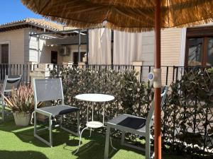 a table and chairs under an umbrella in a yard at Oh! My Hostel in Granada +72 photos