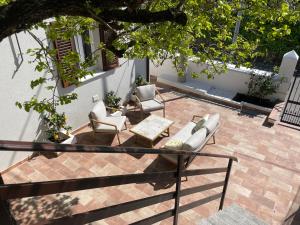 a patio with couches and a table and chairs at Casa Cianetta in San Dorligo della Valle