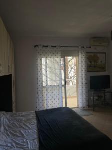 a bedroom with a bed and a sliding glass door at Sior in Golem