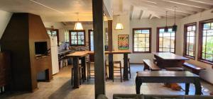 a kitchen and dining room with a table and chairs at Morada Sunset Vista Para o Mar in Praia do Rosa