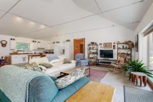 a living room with a couch and a table at Secluded 2 BR Cottage w/ Private W/D, WiFi & Patio in Franklin Road