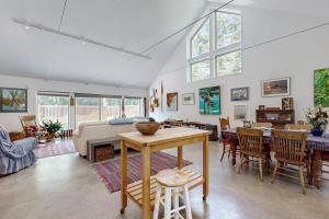a living room with a table and chairs at Secluded 2 BR Cottage w/ Private W/D, WiFi & Patio in Franklin Road