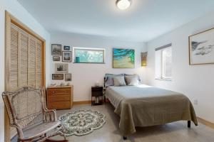 a bedroom with a bed and a chair and a window at Secluded 2 BR Cottage w/ Private W/D, WiFi & Patio in Franklin Road