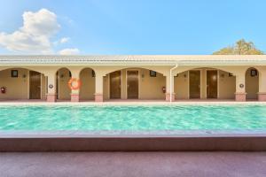 a swimming pool in front of a building at BARA BARA' Budget SATUN 'SHA Plus' in Satun