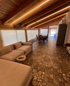 a living room with a couch and a table at Sea View Penthouse in Durrës