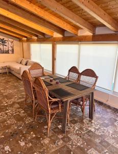 a table and chairs in a room with a couch at Sea View Penthouse in Durrës