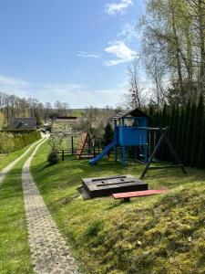 a playground with a slide and a play structure at Agroturystyka Ranczo Turzyniec w pobliżu Zwierzyńca in Turzyniec