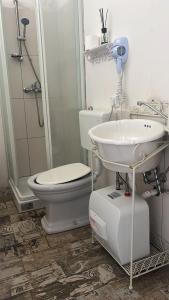 a bathroom with a toilet and a sink at Love Gioia Tauro in Gioia Tauro