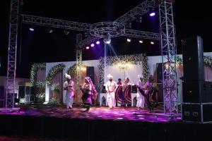 a group of people standing on a stage at Jawla Resort in Palwal +8 photos