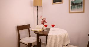 a table with two glasses of wine and a book at Nivara Stays Lingampalli, A Boutique Hotel Brand in Hyderabad +36 photos