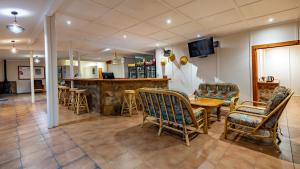 a restaurant with a table and chairs and a bar at Ramabanta Trading Post in Setleketseng