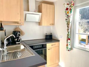 a small kitchen with a sink and a stove at Hilla's Traumhaus in der Eifel in Schleiden