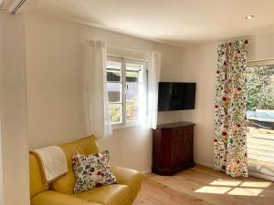 a living room with a couch and a window at Hilla's Traumhaus in der Eifel in Schleiden