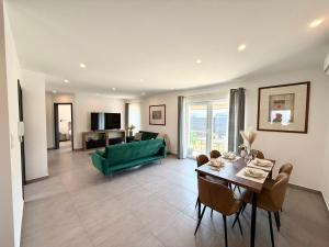 a living room with a green couch and a table at Local-Lux Garden Residence A- 2 Bedrooms-Terrace in Kecskemét