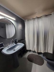 a bathroom with a sink and a mirror and a toilet at MAFILVI Panorama in Chrousa +18 photos