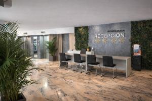 an office lobby with a reception desk and chairs at Ocean View Ponderosa 601 Costa Adeje Playa de las Americas in Costa de Adeje