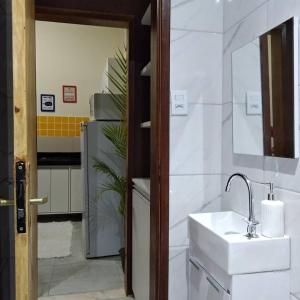 a bathroom with a sink and a mirror at Funcional, cômoda e confortável in Camaçari +63 photos