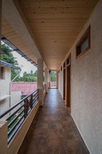 an empty corridor of a building with a wooden ceiling at New Armadale Nainital in Nainital