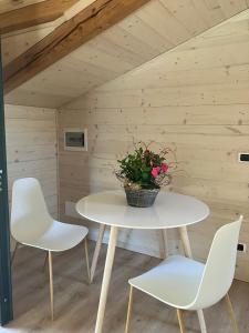 a white table and two chairs and a potted plant at Le Moline b&b in Masserano +12 photos