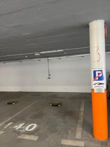 a parking garage with an orange pole in a parking lot at Harmony Apartman in Dunajská Streda