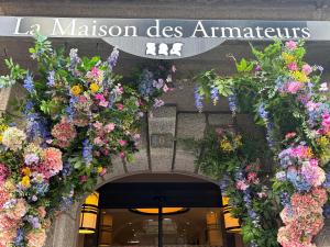 an entrance to a flower shop with a bunch of flowers at La Maison des Armateurs in Saint Malo