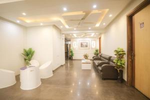 a living room with a couch and some plants at Hotel AR Residency in New Delhi