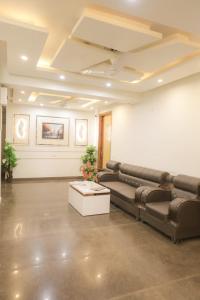 a living room with a couch and a table at Hotel AR Residency in New Delhi