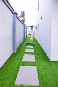 an empty hallway with green grass in a building at Clarence House in Ikeja