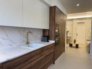 a kitchen with a sink and a counter at Apartamentos Las Mereras in Fuente Palmera +95 photos
