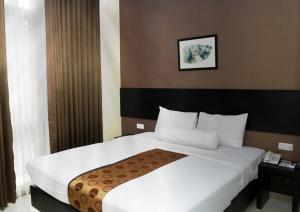 Säng eller sängar i ett rum på Vio Hotel Pasteur