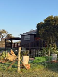 a fence in front of a house at The Cabin at Skyfall Country Estate in Polokwane