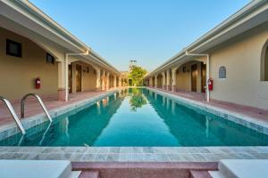 a swimming pool in the middle of a building at BARA BARA' Budget SATUN 'SHA Plus' in Satun