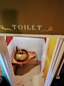 a bathroom with a sink and a toilet sign at The hostel kobe in Kobe
