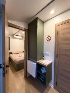 a small bedroom with a bed and a mirror at Kapija Svrljiga in Svrljig